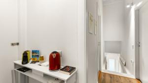 a room with a table with a red appliance on it at Ceramic Rooms in Oristano