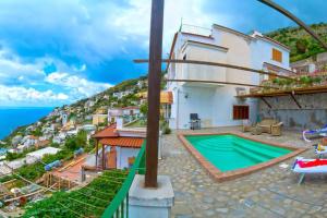 a villa with a swimming pool and a view of the ocean at House Teresa - private pool in Praiano