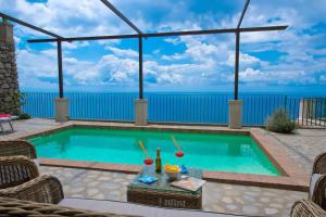 a swimming pool with a view of the ocean at House Teresa - private pool in Praiano