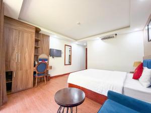 a hotel room with a bed and a couch at Liberty Sapa Hotel in Sapa