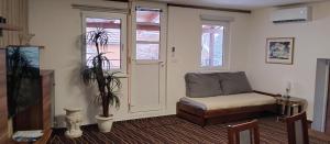 a living room with a chair and a tv at Pension u Veverků in Protivanov