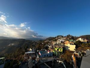 a view of a city from the top of a hill at Uttarayan The Homestay in Almora