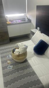 a bedroom with a bed with a basket on the floor at Adriatica Apartamentos in San Luis