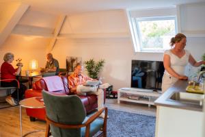 a woman standing in a living room with a man at de lange adem in Millingen aan de Rijn