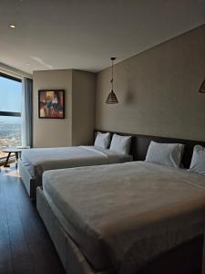a hotel room with two beds and a window at Apec Mandala Sea View Bathtub by MLT in Mui Ne +55 photos
