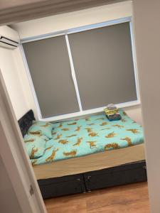 a bed in a room with a large window at Arnhem Bouwmeesterstraat in Arnhem