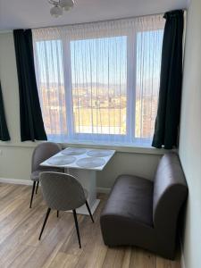 a room with a table and a chair and a window at Atelier SkyLine in Gabrovo