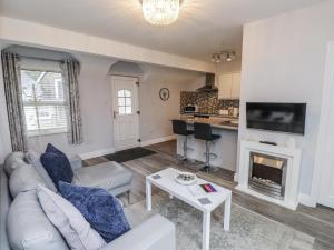 a living room with a couch and a fireplace at The Wren in Colwyn Bay