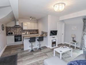 a living room with a couch and a table at The Wren in Colwyn Bay +19 photos