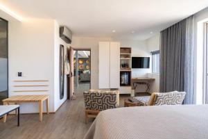 a room with a bed and chairs and a table at Atholl House in Cape Town