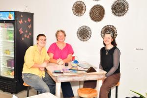 three people sitting at a table in front of a refrigerator at ELOP Resturant & Villa in Piyadigama