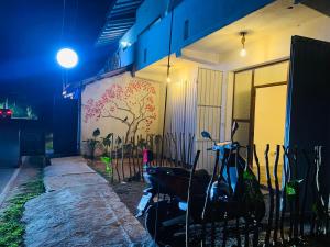 a scooter parked next to a building at night at ELOP Resturant & Villa in Piyadigama
