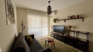 a living room with a couch and a flat screen tv at Luna home in Torrox