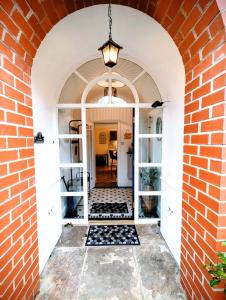 an arched entryway with a brick wall at 2 Bedroom Unique Converted Constabulary in Nantwich