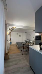 a kitchen and a living room with a table at Vamesu Frontiers - Luxury borders in Sibiu