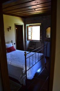 a bedroom with a bed and a staircase with a window at Casa de Fujacos in Valença +35 photos