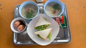a tray with a sandwich and three bowls of soup at ไร่รักดอย ภูทับเบิก in Ban Maeo Thap Boek