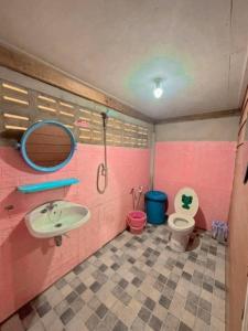 a pink bathroom with a sink and a toilet at Yada homestay in Ban Bu Lu +24 photos