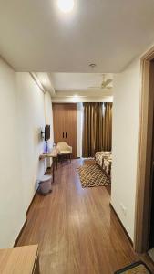 a living room with a bed and a table and a room at Skybloom stays in Greater Noida