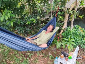 a man is laying in a hammock at Villa iSoNet in Weligama