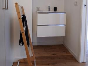 a ladder standing in a room with a refrigerator at Il monolocale in Bosisio Parini