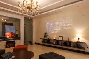 a living room with a chandelier and a fireplace at Beloved Summer House in Hanoi