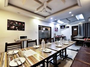 a dining room with a long table and chairs at Hotel Aerocity Purple Orchid in New Delhi