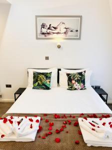 a bedroom with a bed with red roses on the floor at Fox House, Studio Apartments in Plymouth