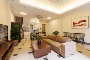 a living room with a couch and a table at Beloved Summer House in Hanoi