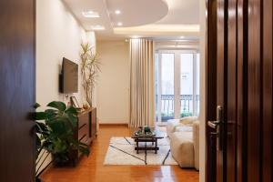 a living room with a couch and a tv at Beloved Summer House in Hanoi +71 photos