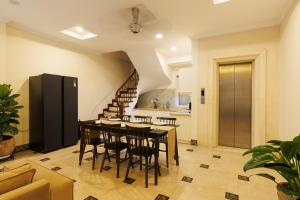 a kitchen and dining room with a table and chairs at Beloved Summer House in Hanoi