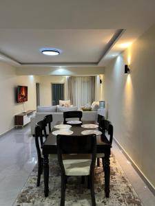 a dining room with a table and a couch at pk Luxury Homes in Nairobi