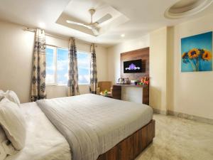 a bedroom with a large bed and a window at Hotel Aerocity Purple Orchid in New Delhi