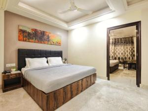 a bedroom with a large bed and a mirror at Hotel Aerocity Purple Orchid in New Delhi +67 photos