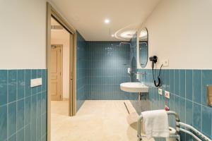 a blue bathroom with a sink and a mirror at Hotel San Lorenzo Boutique Catedral in Valencia +51 photos
