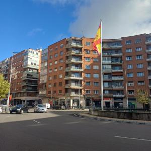 a large building with a flag in front of it at La Palentina in Palencia
