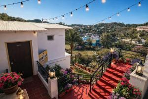 a balcony of a house with flowers and lights at Sky Mount Villa in Mount Ābu