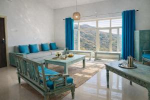 a living room with a couch and a table at Sky Mount Villa in Mount Ābu