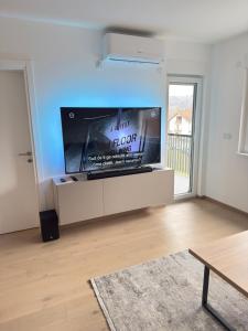 a living room with a large flat screen tv at Level Apartment in Kostajnica