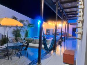 a pool with a hammock next to a table and an umbrella at Casa vacacional SAMUEL in Honda +12 photos