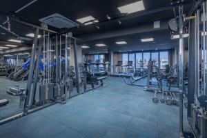 a gym with treadmills and elliptical machines at Hotel City Break in Galaţi