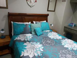 a bed with blue and white sheets and pillows at Cabanas 21 in Kingsborough +19 photos