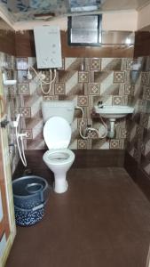 a bathroom with a toilet and a sink at Danny's Homestay Coorg in Madikeri