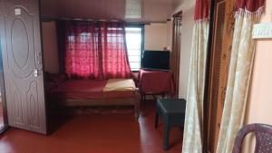 a small bedroom with a bed and a window at Danny's Homestay Coorg in Madikeri