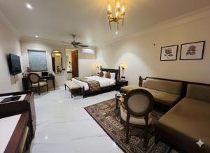 a bedroom with a bed and a living room at Roop Garh Palace, Jaipur in Jaipur