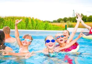 a group of people swimming in a swimming pool at Holiday Park Zator in Zator