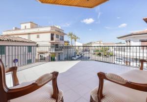 a patio with two chairs and a table on a balcony at Can Maro in Santa Margalida