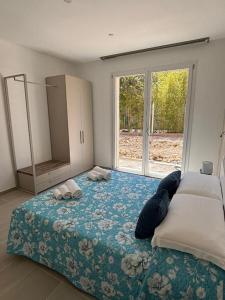 a bedroom with a bed and a large window at Acquaviva Suite in San Vincenzo