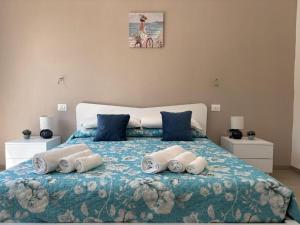 a bedroom with a bed with towels on it at Acquaviva Suite in San Vincenzo
