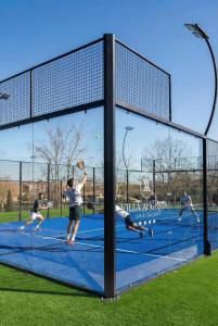 a group of men playing tennis on a tennis court at Villa Augusta Spa & Garden in Valladolid